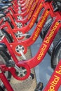 Row of Red Bicycles Used in the Capital Bikeshare Program Resting on the sidewalk #1