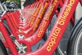 Row of Red Bicycles Used in the Capital Bikeshare Program Resting on the sidewalk #3