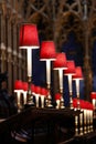 Row of red candles in the interior of Westminster Abbey, UK