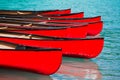 Row of red canoes in lake Royalty Free Stock Photo