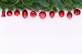 A Row of Red Christmas Baubles on fir branches. Royalty Free Stock Photo