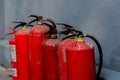 A row of fire extinguishers against the wall Royalty Free Stock Photo