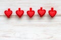 Row of red dotted hearts on clothespins at wooden border. Valentine`s day background. Happy love concept