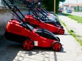 Small equipment store with row of red lawnmowers on the street Royalty Free Stock Photo