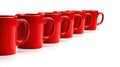A row of red mugs on a white background. Royalty Free Stock Photo
