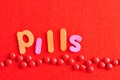 A row of red pills with the word pills Royalty Free Stock Photo