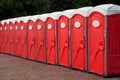 Row of Red Portable Toilets