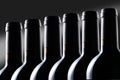 Row of red wine bottle isolated on black background with clipping path and copy space for your text Royalty Free Stock Photo