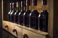 Row of red wine bottles on a wooden shelf, created with generative AI Royalty Free Stock Photo
