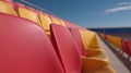 A row of red and yellow seats in a stadium Royalty Free Stock Photo