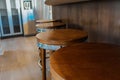 Row of retro wooden stools in front of wooden counter inside a modern style kitchen Royalty Free Stock Photo