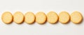 Row of round golden crackers on white background Royalty Free Stock Photo