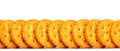 Row of round golden crackers on white background Royalty Free Stock Photo