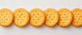 Row of round golden crackers on white background Royalty Free Stock Photo