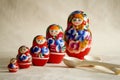 Row Russian Matryoshkas and two wooden spoons Royalty Free Stock Photo