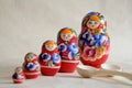 Row Russian Matryoshkas and two wooden spoons Royalty Free Stock Photo
