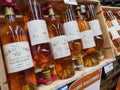 Row of Sauternes Bottles, French sweet wine display for sell in the supermarket shelves