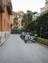 Row of scooters parked in a courtyard in Rome