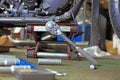 Row of screws and wrench tools on a floor in workshop near repaired old bike or motorcycle engine. Industrial scene with Royalty Free Stock Photo