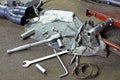 Row of screws and wrench tools on a floor in workshop near repaired old bike or motorcycle engine. Industrial scene with Royalty Free Stock Photo