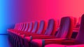 Row of seats under vibrant neon lights in an empty theater