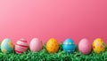 Colorful Easter Eggs on Green Grass Against Pink Background Royalty Free Stock Photo