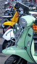 A row of seven mopeds front wheels