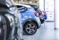 Row of shiny cars for sale parked in a showroom interior Royalty Free Stock Photo