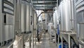 Row of shiny metal micro brewery tanks or Fermentation mash vats in Brewery factory Royalty Free Stock Photo