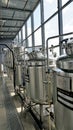 Row of shiny metal micro brewery tanks or Fermentation mash vats in Brewery factory Royalty Free Stock Photo