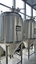 Row of shiny metal micro brewery tanks or Fermentation mash vats in Brewery factory Royalty Free Stock Photo