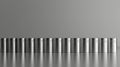 Row of shiny metallic cans reflecting on a glossy surface Royalty Free Stock Photo