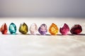 row of shiny rough gemstones placed on a marble background