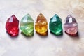 row of shiny rough gemstones placed on a marble background