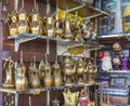 Row of shiny traditional coffee pots and lamp