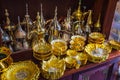 Row of shiny traditional coffee pots and lamp Royalty Free Stock Photo