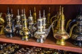 Row of shiny traditional coffee pots and lamp Royalty Free Stock Photo