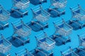 A row of shopping carts are lined up on a blue background Royalty Free Stock Photo