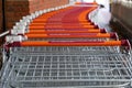 A row of shopping trollies or shopping carts outside a supermarket