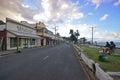 Row of shops, main road Beach Street & local Fijian chatting near sunset at Levuka, Ovalau island, Fiji Royalty Free Stock Photo