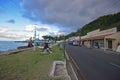 Row of shops, main road Beach Street & local Fijian sitting on public bench at Levuka, Ovalau island, Fiji Royalty Free Stock Photo