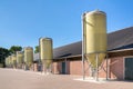 Feed silos in a row at cattle shed Royalty Free Stock Photo