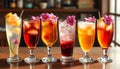 Row of six drinks with flowers on top Royalty Free Stock Photo