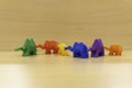 A row of six toy camels of different colors, holding each others tails. Diversity concept. Unique, but still united.