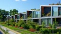 A row of sleek energyefficient buildings with angled windows and rooftop gardens designed to reduce heat absorption and