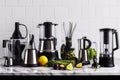 a row of sleek and modern kitchen gadgets, including a juicer, blender and food processor