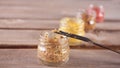 Row of small bottles of mustard on the wooden background