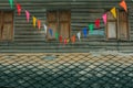 Row of small color flags hanging in the street and decorate the Royalty Free Stock Photo