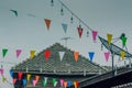 Row of small color flags hanging in the street and decorate the Royalty Free Stock Photo