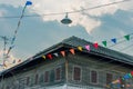 Row of small color flags hanging in the street and decorate the Royalty Free Stock Photo